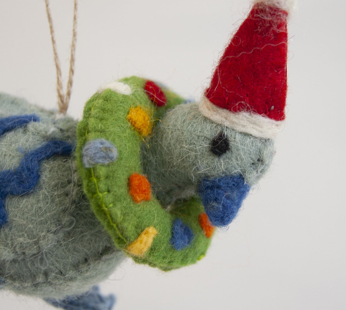 Felted pigeon ornament with a red hat and colorful details on a white background - ZWEIBIE