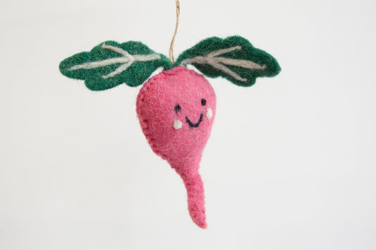 Pink felt radish ornament with a smiling face on a white background